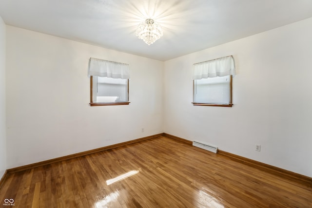 2635 15th St, Columbus, IN 47201 - unfurnished room featuring a chandelier, wood finished floors, and healthy amount of natural light