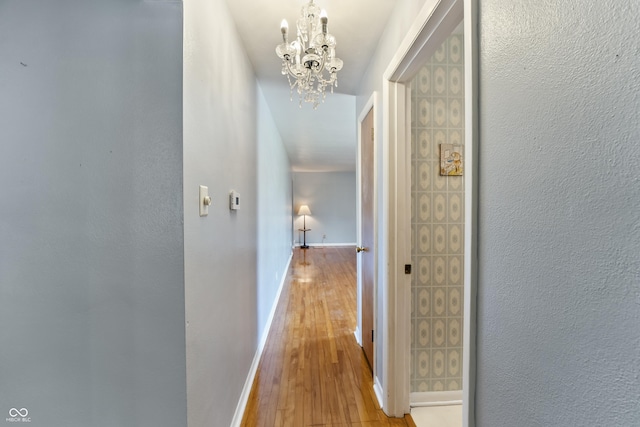 2635 15th St, Columbus, IN 47201 - corridor featuring light wood finished floors and a chandelier