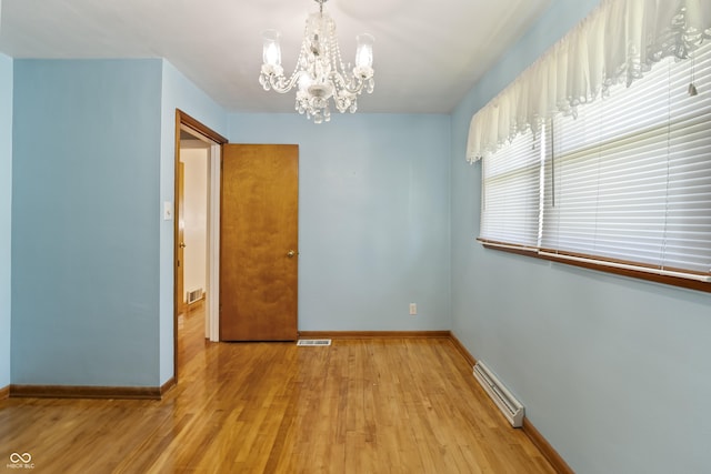 2635 15th St, Columbus, IN 47201 - unfurnished dining area featuring a chandelier, light wood-type flooring, and baseboard heating