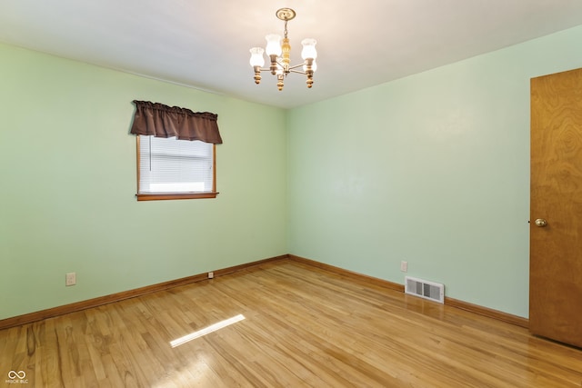 2635 15th St, Columbus, IN 47201 - unfurnished room featuring a chandelier and light wood-style floors