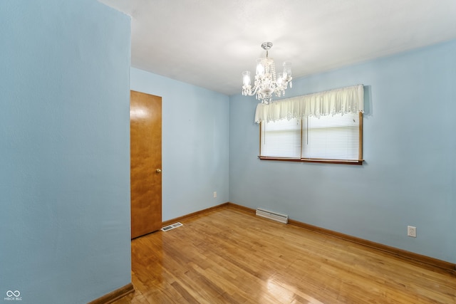 2635 15th St, Columbus, IN 47201 - unfurnished room with a chandelier and wood finished floors