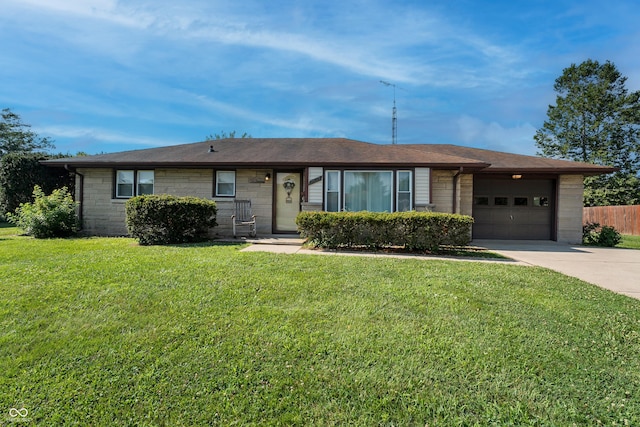 2635 15th St, Columbus, IN 47201 - ranch-style house featuring an attached garage, concrete driveway, and stone siding