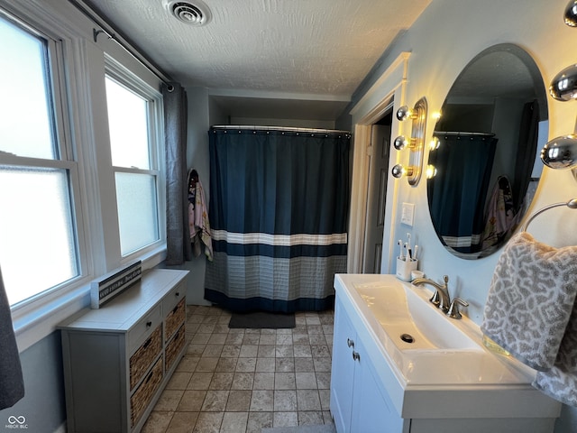 215 N Main St, Batesville, IN 47006 - full bathroom featuring vanity, a textured ceiling, stone finish flooring, and curtained shower