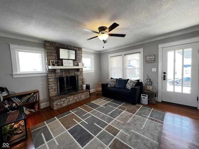 215 N Main St, Batesville, IN 47006 - living area with ornamental molding, a ceiling fan, wood finished floors, a fireplace, and a textured ceiling