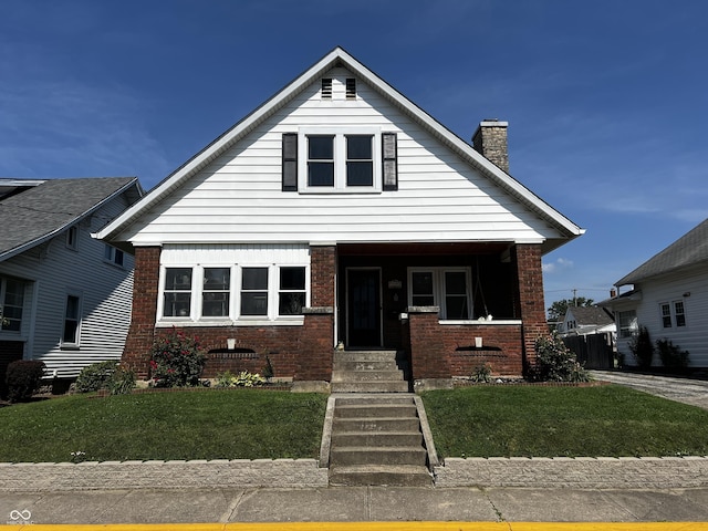 215 N Main St, Batesville, IN 47006 - bungalow-style home featuring brick siding, a chimney, and a front lawn