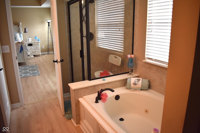 5817 Mustang Ter, Plainfield, IN 46168 - bathroom with a jetted tub, wood finished floors, and a stall shower