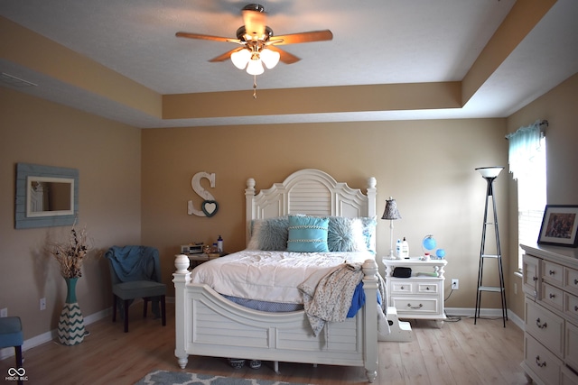 5817 Mustang Ter, Plainfield, IN 46168 - bedroom with light wood-type flooring, a raised ceiling, and ceiling fan