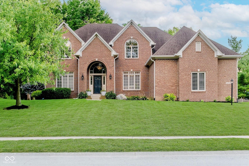 11531 Woods Bay Ln, Indianapolis, IN 46236 - view of front facade with a front yard, brick siding, and a shingled roof