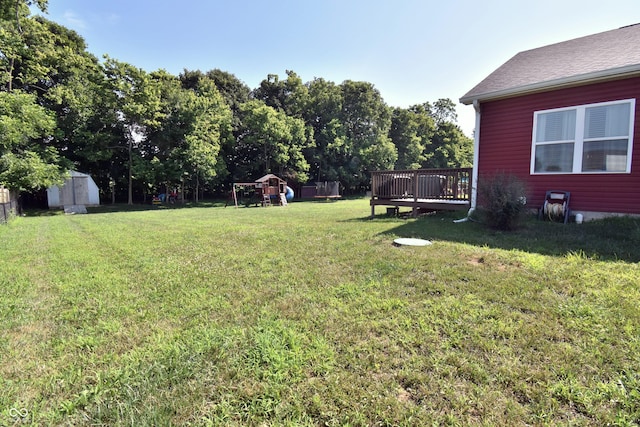 6362 W Friends Way Ct, Paragon, IN 46166 - view of green lawn featuring a playground, a storage shed, and a wooden deck