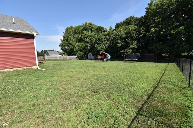 6362 W Friends Way Ct, Paragon, IN 46166 - fenced backyard featuring a trampoline and a playground