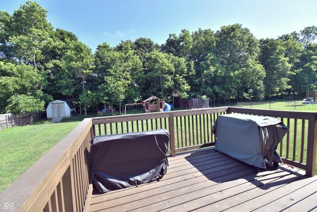 6362 W Friends Way Ct, Paragon, IN 46166 - wooden terrace with a playground, a shed, a fenced backyard, area for grilling, and view of wooded area