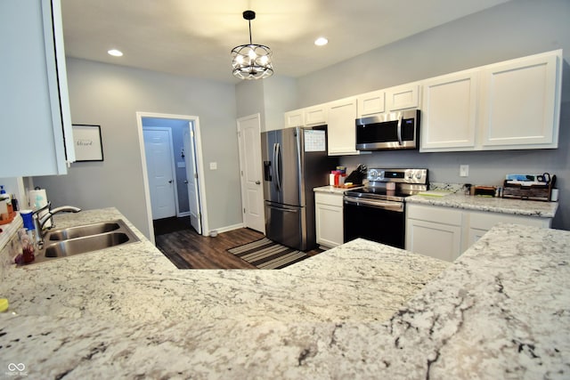 6362 W Friends Way Ct, Paragon, IN 46166 - kitchen featuring stainless steel appliances, dark wood-style floors, white cabinetry, recessed lighting, and decorative light fixtures