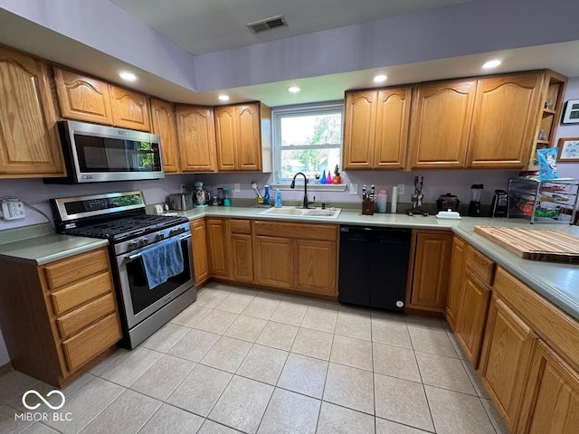 1214 Lindsey Ln, Lebanon, IN 46052 - kitchen with stainless steel appliances, light tile patterned flooring, brown cabinets, light countertops, and recessed lighting