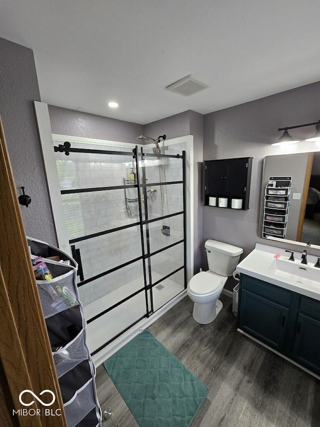 1214 Lindsey Ln, Lebanon, IN 46052 - bathroom with wood finished floors, a shower stall, vanity, and a textured wall
