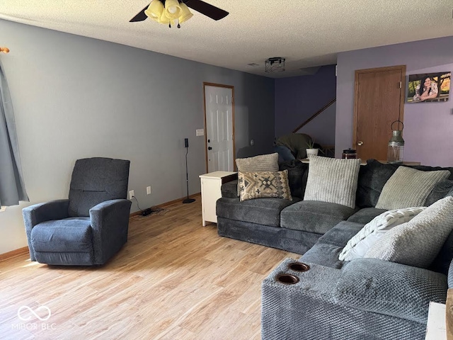 1214 Lindsey Ln, Lebanon, IN 46052 - living room with light wood-style floors, ceiling fan, and a textured ceiling