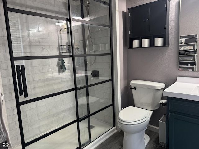 1214 Lindsey Ln, Lebanon, IN 46052 - bathroom featuring a textured wall, vanity, a shower stall, and wood finished floors