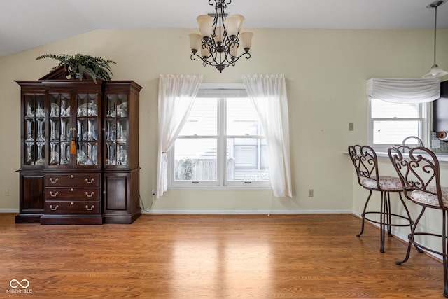 10721 Chesapeake Dr S, Indianapolis, IN 46236 - dining space with a chandelier, wood finished floors, and vaulted ceiling