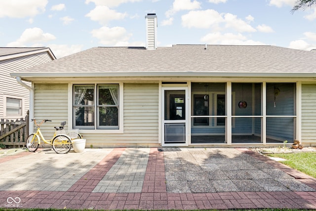 10721 Chesapeake Dr S, Indianapolis, IN 46236 - rear view of property featuring a patio, a shingled roof, and a sunroom