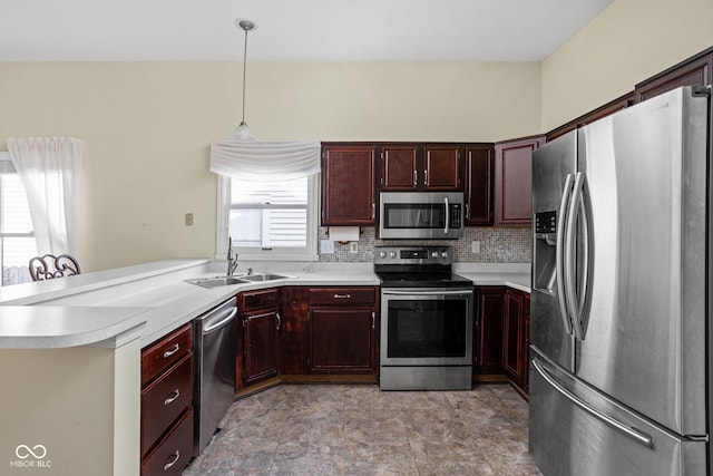 10721 Chesapeake Dr S, Indianapolis, IN 46236 - kitchen featuring stainless steel appliances, light countertops, decorative light fixtures, tasteful backsplash, and a peninsula