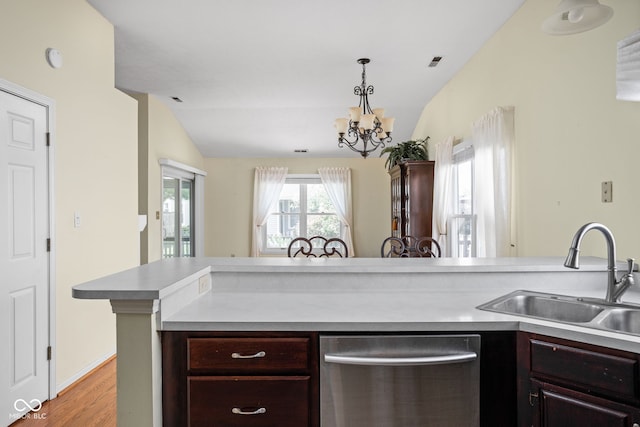 10721 Chesapeake Dr S, Indianapolis, IN 46236 - kitchen featuring stainless steel dishwasher, light countertops, light wood finished floors, a chandelier, and dark brown cabinets