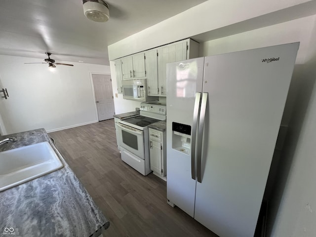 1615 S 9th Ave, Beech Grove, IN 46107 - kitchen featuring white appliances, dark wood-style flooring, ceiling fan, and white cabinetry