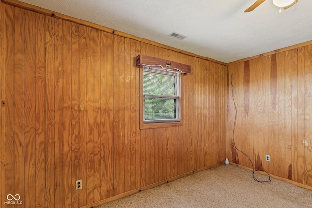 8701 E Splinter Ridge Rd, Madison, IN 47250 - empty room with a ceiling fan, wood walls, and carpet flooring