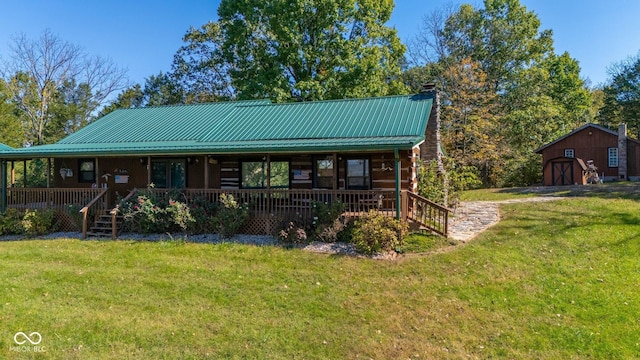 8701 E Splinter Ridge Rd, Madison, IN 47250 - view of front of house with a porch, a front lawn, a chimney, and a metal roof