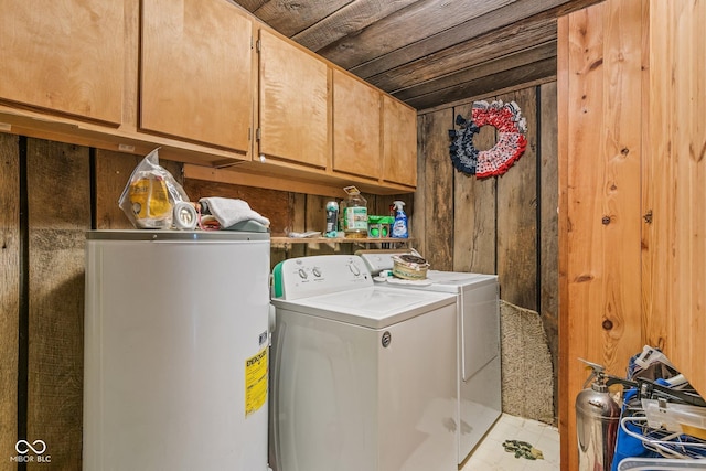 8701 E Splinter Ridge Rd, Madison, IN 47250 - laundry area featuring electric water heater, cabinet space, separate washer and dryer, and wooden walls