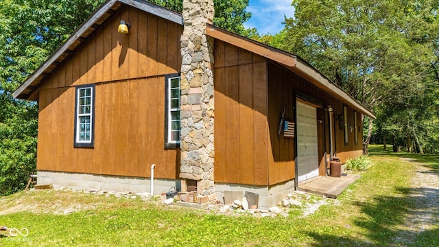 8701 E Splinter Ridge Rd, Madison, IN 47250 - view of home's exterior featuring a chimney, a yard, and a garage