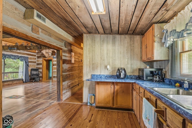 8701 E Splinter Ridge Rd, Madison, IN 47250 - kitchen featuring wood ceiling, black microwave, brown cabinets, light wood-style flooring, and dark countertops