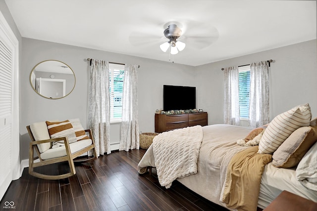 5456 N Park Dr, Indianapolis, IN 46220 - bedroom featuring multiple windows, dark wood-style floors, baseboard heating, and a ceiling fan