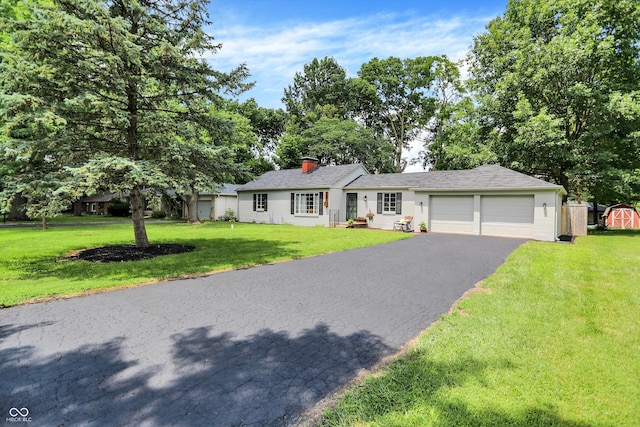 5456 N Park Dr, Indianapolis, IN 46220 - ranch-style house with a garage, a front yard, driveway, a shed, and a chimney