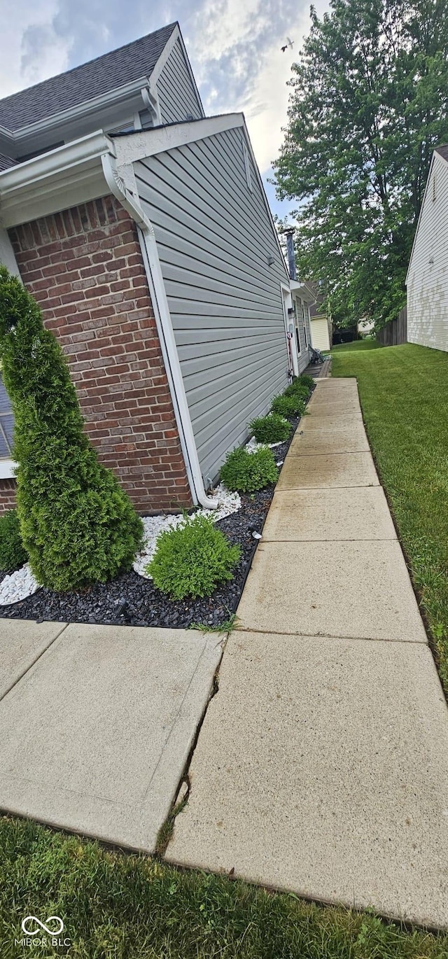 5648 Hyacinth Way, Indianapolis, IN 46254 - view of side of property featuring brick siding and a yard