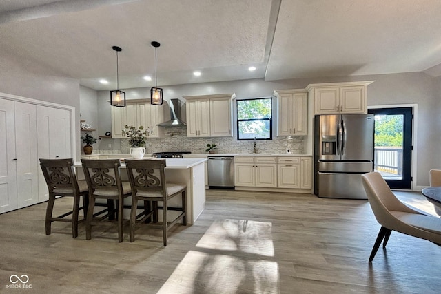 1440 S New Jersey St, Indianapolis, IN 46225 - kitchen with stainless steel appliances, wall chimney range hood, light countertops, light wood-style floors, and tasteful backsplash