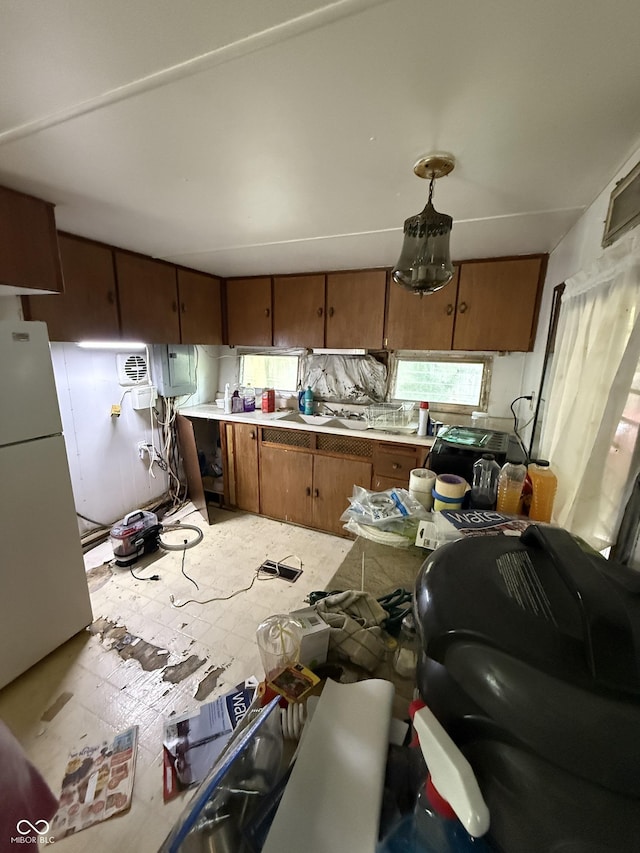 133 Michigan St, Clayton, IN 46118 - kitchen featuring freestanding refrigerator, brown cabinets, and light countertops
