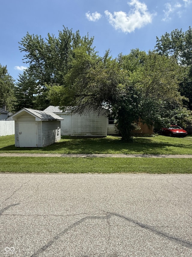 133 Michigan St, Clayton, IN 46118 - view of side of home with a shed and a lawn