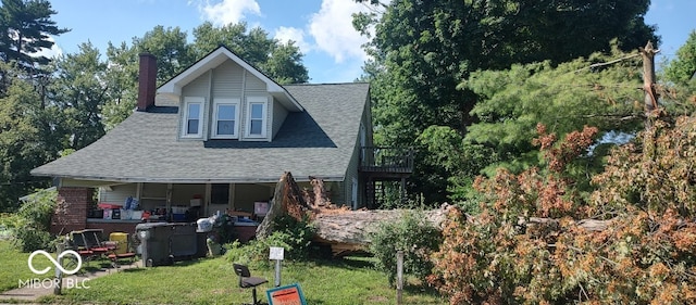 202 E Pearl St, Trafalgar, IN 46181 - back of house with a shingled roof, a yard, and a chimney