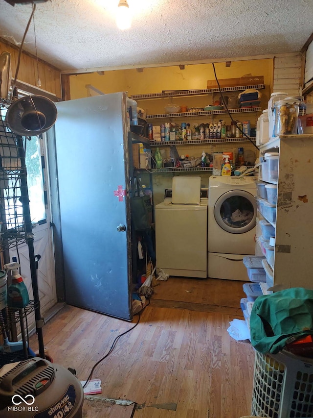 202 E Pearl St, Trafalgar, IN 46181 - laundry room featuring washer and dryer, a textured ceiling, and wood finished floors