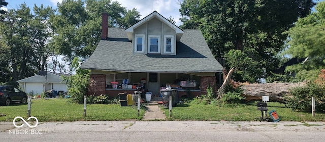202 E Pearl St, Trafalgar, IN 46181 - view of front of property featuring a shingled roof, covered porch, a front lawn, a chimney, and brick siding