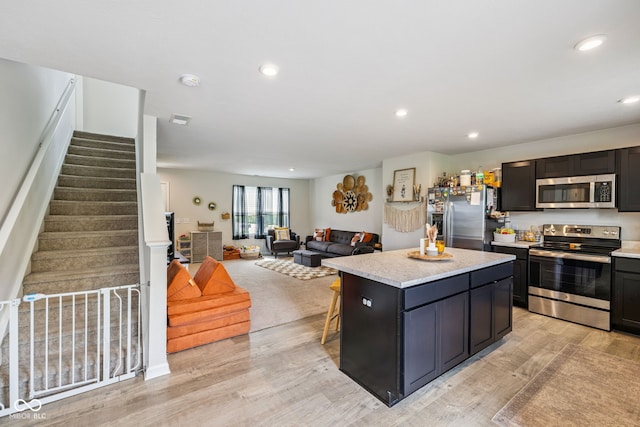 197 N Fairfield Dr, Danville, IN 46122 - kitchen with stainless steel appliances, a center island, light wood-type flooring, light countertops, and recessed lighting