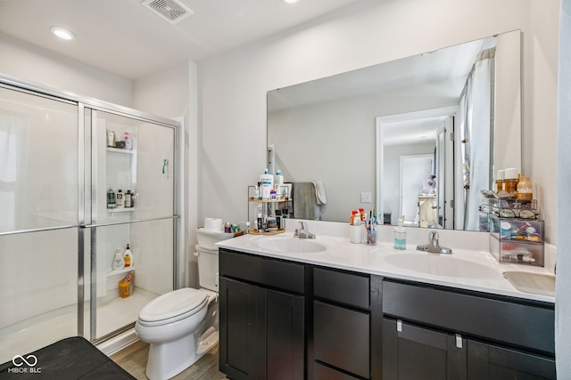 197 N Fairfield Dr, Danville, IN 46122 - bathroom featuring double vanity, a stall shower, wood finished floors, and recessed lighting