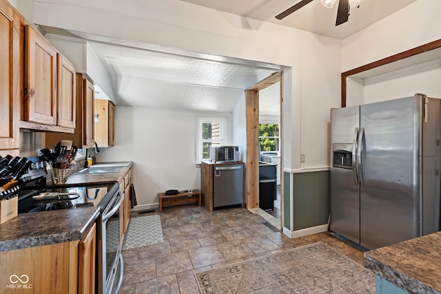 631 S State Road 39, Danville, IN 46122 - kitchen with stainless steel appliances, a ceiling fan, dark countertops, stone finish floors, and brown cabinets