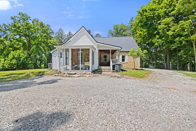 631 S State Road 39, Danville, IN 46122 - bungalow with a chimney, a porch, a metal roof, and gravel driveway