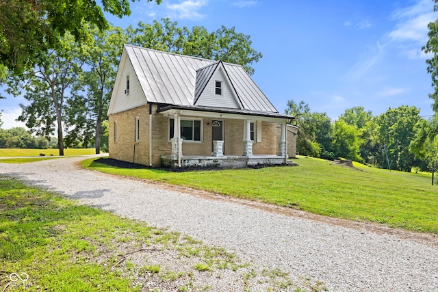 631 S State Road 39, Danville, IN 46122 - bungalow-style house featuring brick siding, a standing seam roof, covered porch, and a front yard