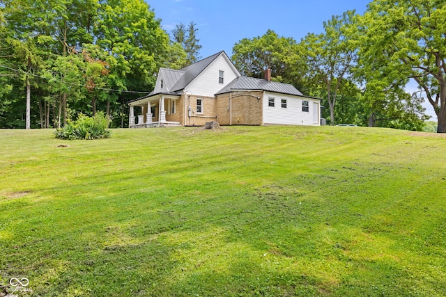 631 S State Road 39, Danville, IN 46122 - back of property with a chimney, a metal roof, a yard, and a standing seam roof
