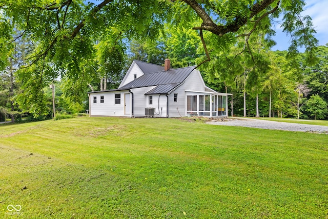 631 S State Road 39, Danville, IN 46122 - view of front facade with a sunroom, a chimney, a front lawn, a metal roof, and a standing seam roof
