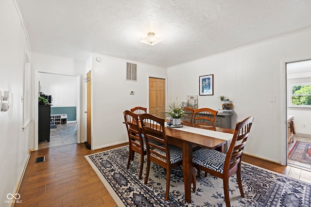 631 S State Road 39, Danville, IN 46122 - dining space featuring wood-type flooring, a textured ceiling, and ornamental molding