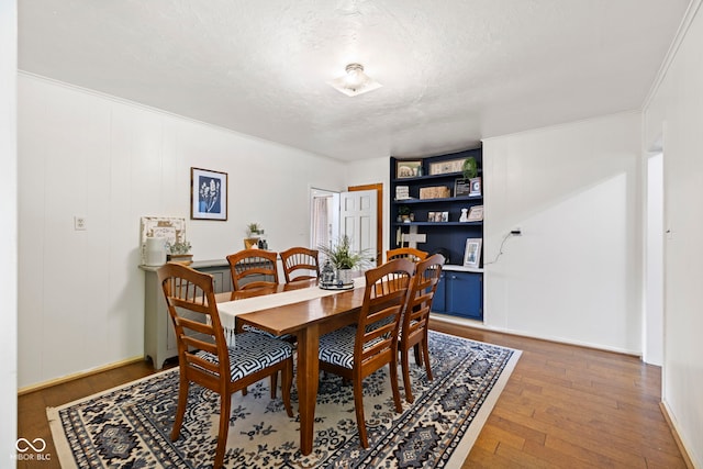631 S State Road 39, Danville, IN 46122 - dining space with wood finished floors, a textured ceiling, and crown molding