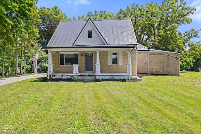 631 S State Road 39, Danville, IN 46122 - view of front facade with a porch, brick siding, a front yard, and a metal roof