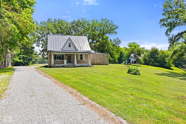 631 S State Road 39, Danville, IN 46122 - view of front facade with gravel driveway, covered porch, a front yard, and a metal roof